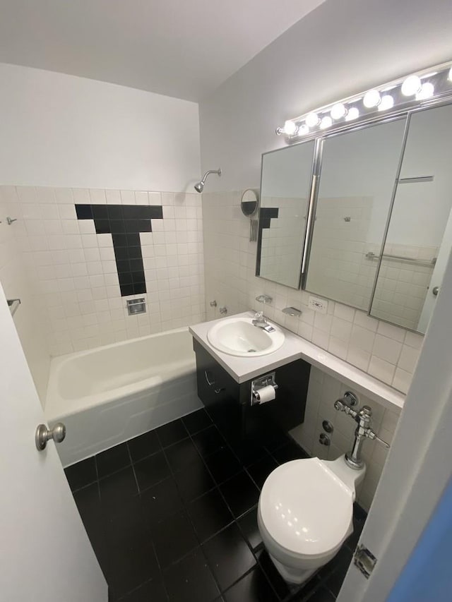 bathroom with tile patterned flooring, vanity, and washtub / shower combination