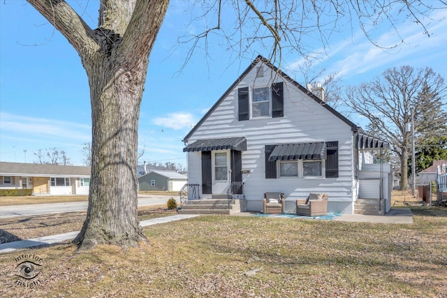 bungalow-style home with a front lawn