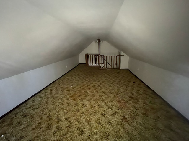 bonus room featuring vaulted ceiling and carpet flooring