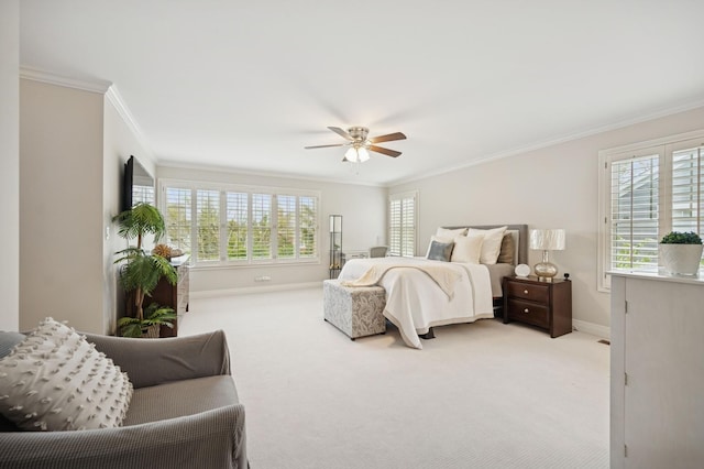 carpeted bedroom featuring ornamental molding, baseboards, and a ceiling fan