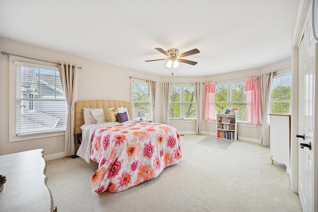 bedroom with baseboards, light carpet, and ceiling fan
