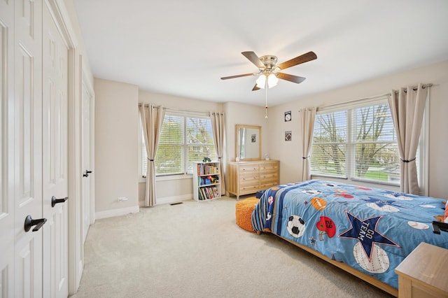 bedroom with carpet flooring, baseboards, and ceiling fan