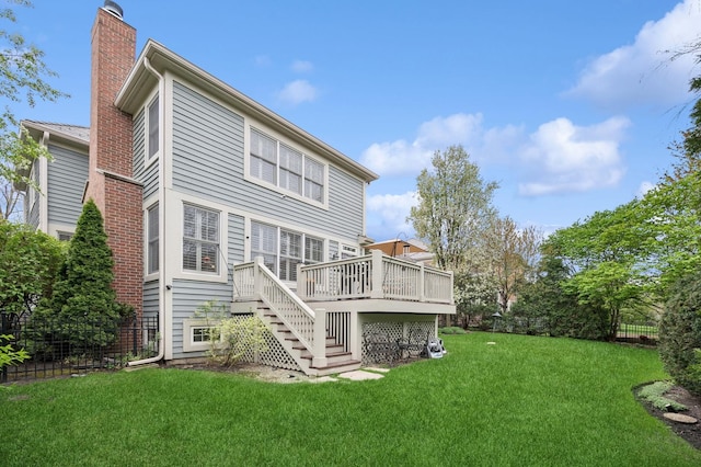 back of house with fence, stairs, a wooden deck, a chimney, and a lawn