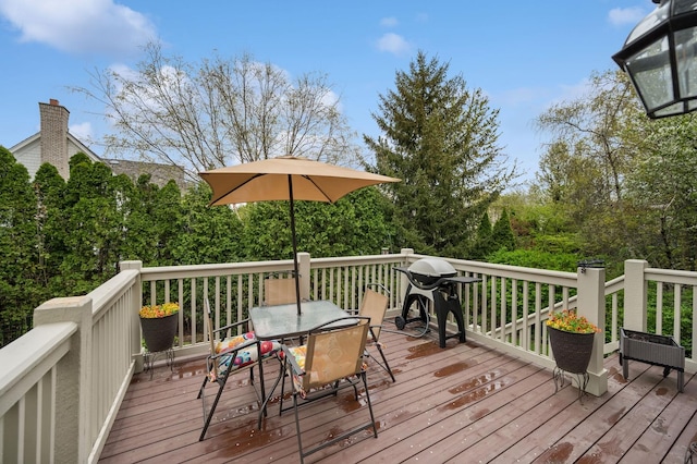 wooden deck featuring outdoor dining space