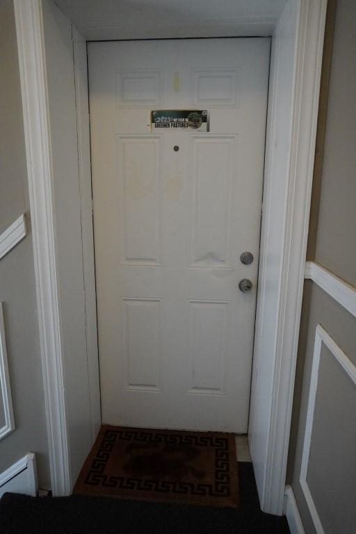 entrance to property with a baseboard heating unit