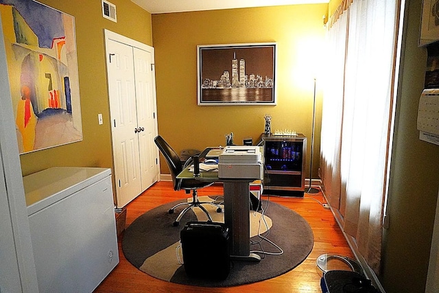 office space with visible vents and light wood-style flooring