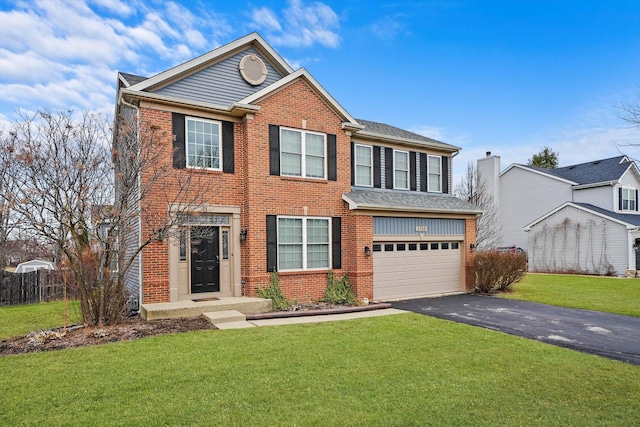view of front of house with fence, driveway, an attached garage, a front lawn, and brick siding