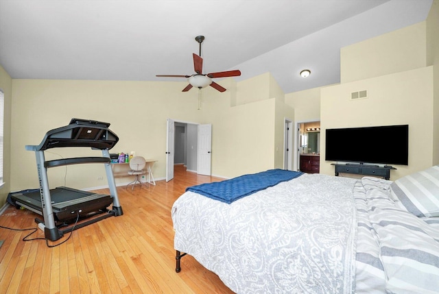 bedroom featuring visible vents, baseboards, high vaulted ceiling, and hardwood / wood-style floors