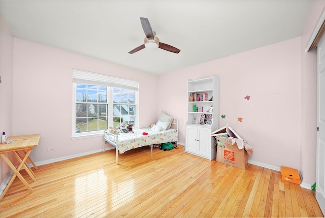 bedroom featuring a closet, a ceiling fan, baseboards, and wood-type flooring
