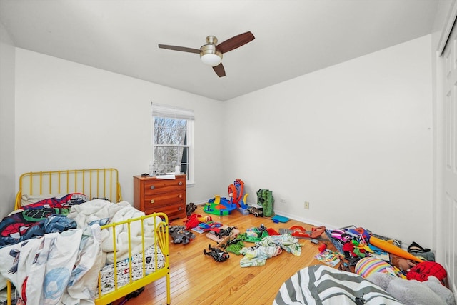 bedroom with wood finished floors, a closet, and ceiling fan
