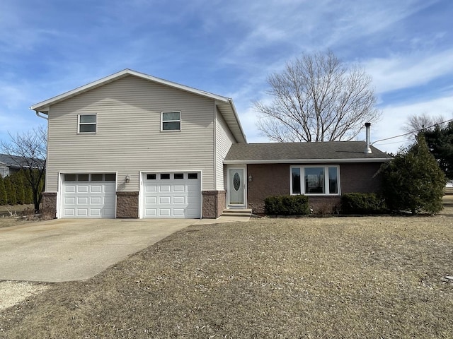 view of front facade with brick siding, an attached garage, and concrete driveway