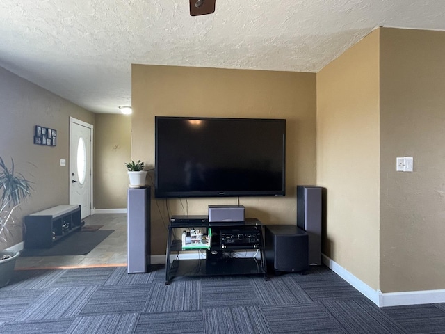 living room featuring a textured ceiling, baseboards, and dark colored carpet