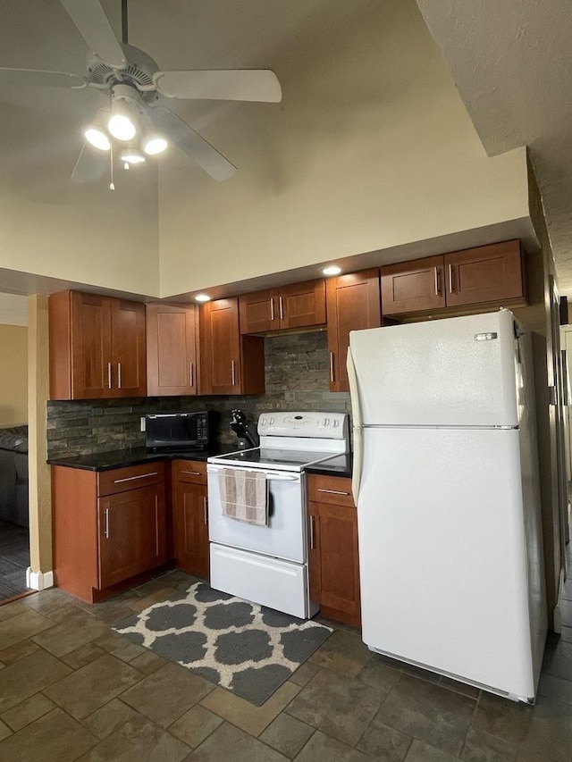 kitchen with white appliances, high vaulted ceiling, stone finish floor, dark countertops, and tasteful backsplash