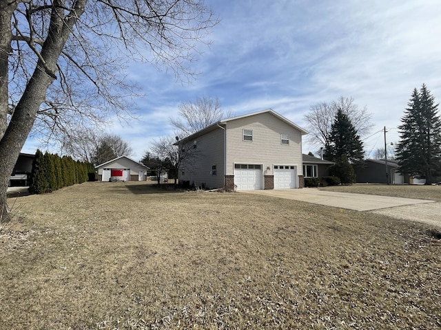 view of property exterior featuring a lawn, a garage, and driveway