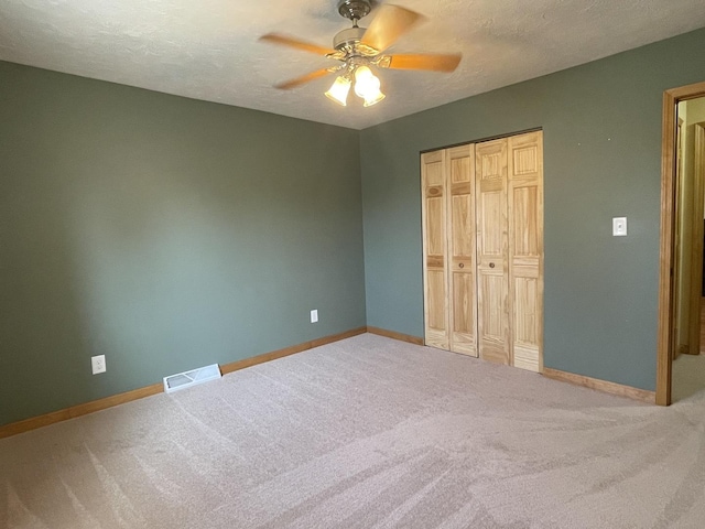 unfurnished bedroom featuring baseboards, visible vents, a closet, and a textured ceiling