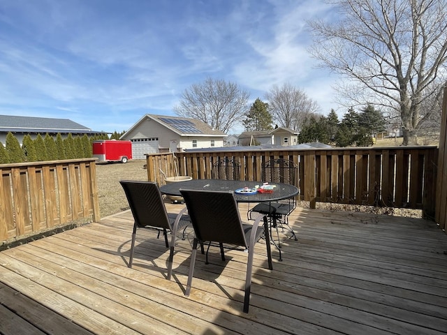 deck featuring outdoor dining space and an outdoor structure