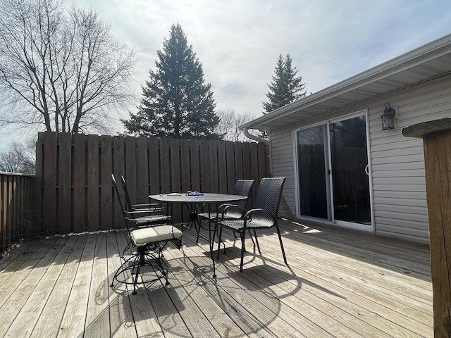 deck with outdoor dining space and fence