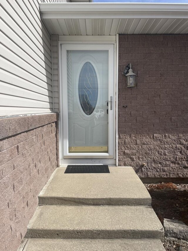 property entrance featuring brick siding