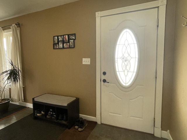 tiled foyer entrance with baseboards