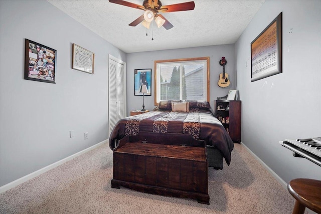 bedroom featuring a closet, a textured ceiling, baseboards, and carpet