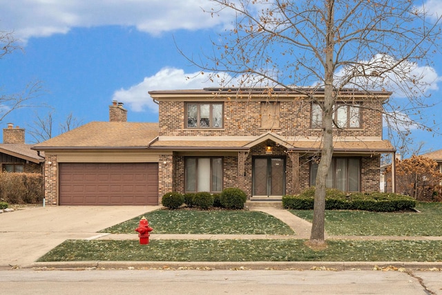 traditional-style home with brick siding, an attached garage, driveway, and a front lawn