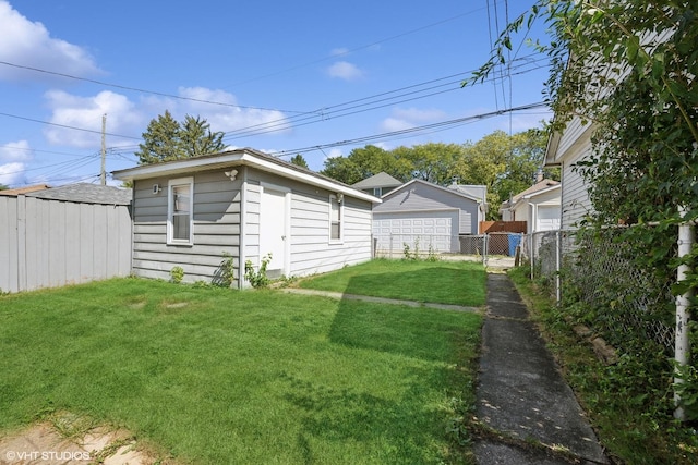 view of yard with an outdoor structure, fence, and a garage