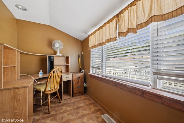 home office featuring visible vents, baseboards, and vaulted ceiling