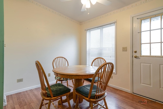 dining room with light wood-style flooring, baseboards, and ceiling fan