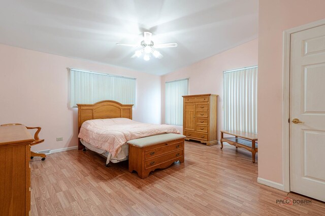 bedroom featuring ceiling fan, baseboards, and light wood-style floors