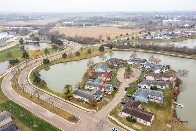 drone / aerial view featuring a residential view, a water view, and a rural view