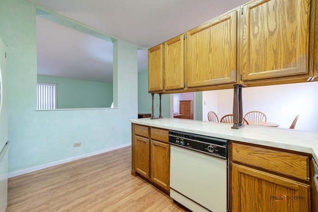 kitchen featuring brown cabinetry, baseboards, light wood-style flooring, light countertops, and dishwasher