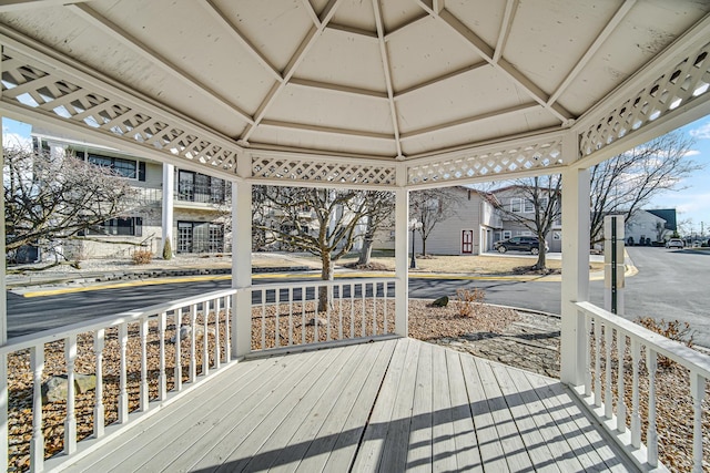 wooden deck with a gazebo and covered porch