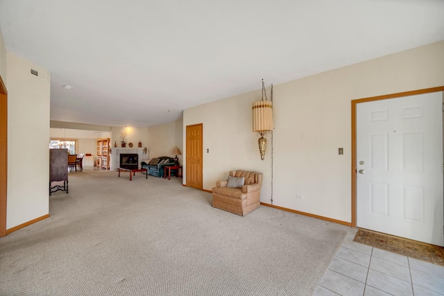 interior space with visible vents, baseboards, and light colored carpet