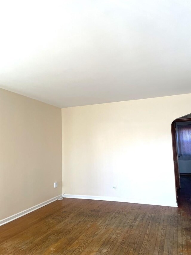 interior space featuring baseboards and wood-type flooring