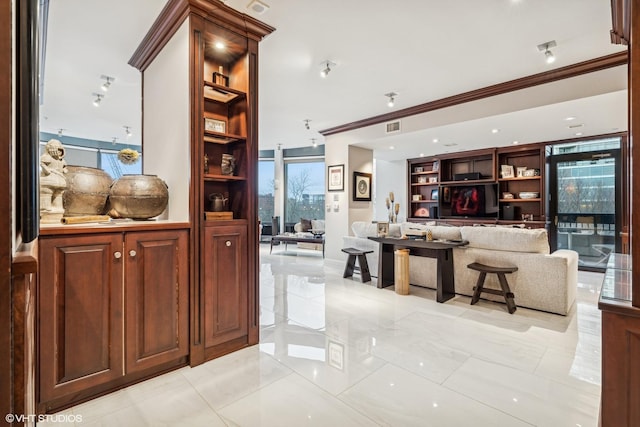 interior space with visible vents, built in features, and ornamental molding