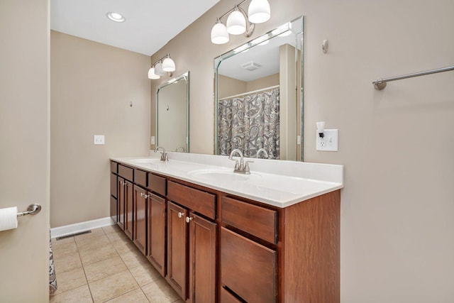 full bath with a sink, visible vents, double vanity, and tile patterned flooring