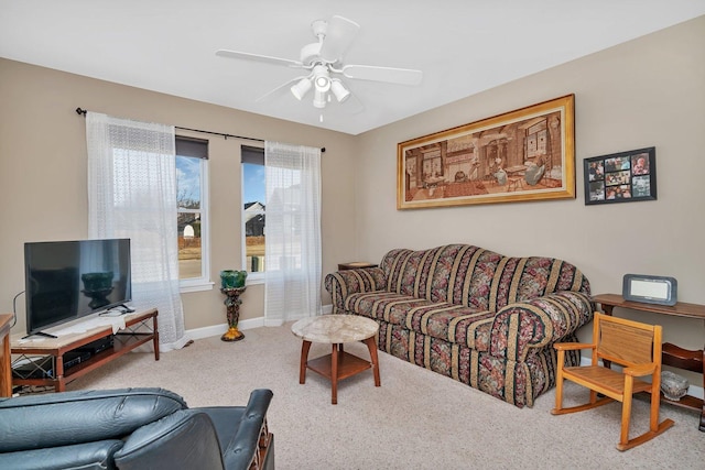 living area with baseboards, carpet, and ceiling fan