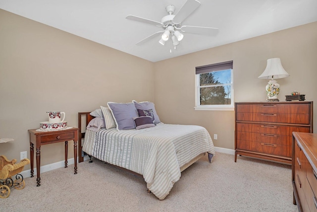 bedroom featuring baseboards, light carpet, and a ceiling fan