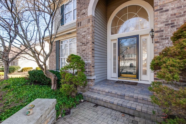 property entrance with brick siding