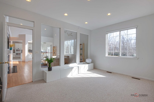 bathroom with a wealth of natural light, visible vents, and recessed lighting