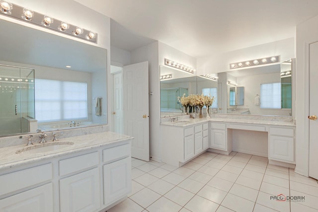 full bathroom featuring vanity, a shower stall, a bathing tub, and tile patterned floors