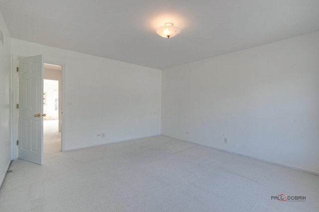 spare room with light carpet