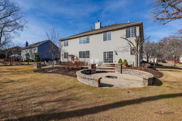 back of property featuring an outdoor fire pit, a patio area, a lawn, and a chimney