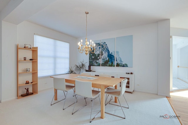 dining space featuring baseboards and a chandelier