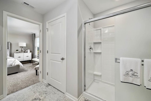 ensuite bathroom featuring visible vents, a stall shower, ensuite bath, and baseboards