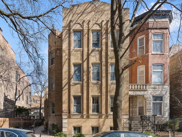 view of building exterior with a fenced front yard