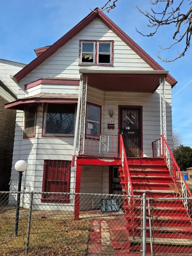 bungalow-style house featuring a fenced front yard, covered porch, and a gate