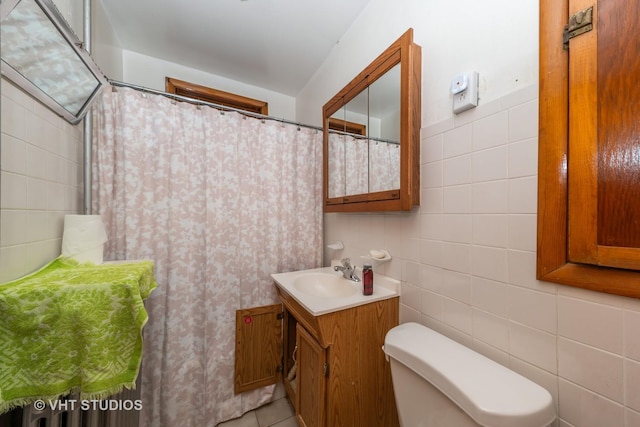 full bathroom with tile patterned floors, toilet, a shower with shower curtain, tile walls, and vanity