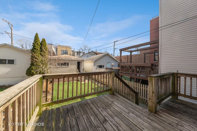 wooden deck featuring a yard