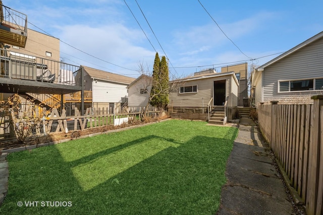 view of yard with a fenced backyard and entry steps